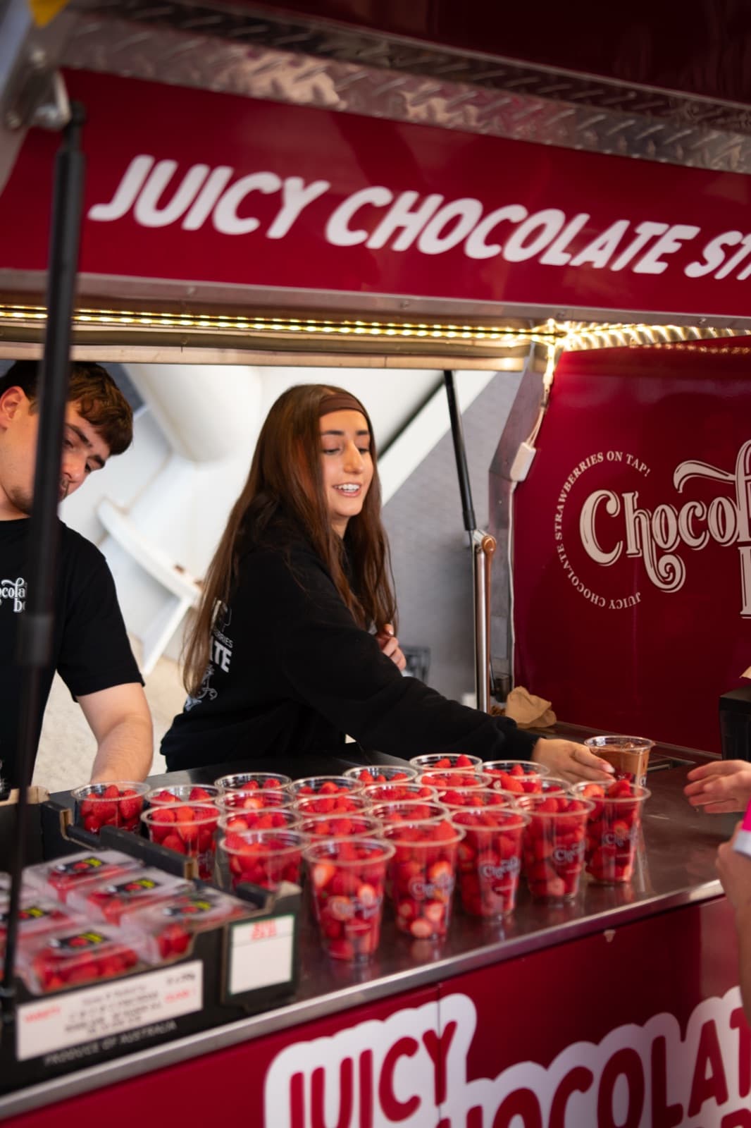 Chocolate Boys team smiling behind rows of strawberry cups