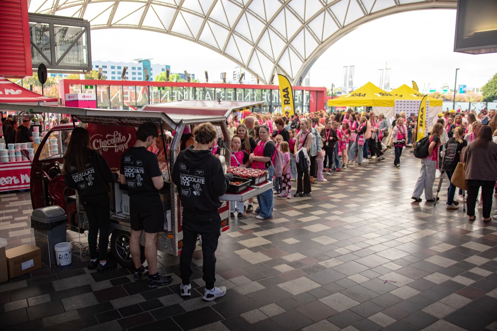 The Chocolate Boys tuk-tuk with a massive crowd stretching into the distance